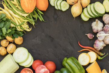 Fresh vegetables on a black background Zucchini Tomatoes Cucumbers Carrots Potatoes String Beans Healthy Food Copy Space Agriculture Top view