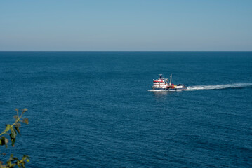 Amasra city, fishing boat at water with blue sky and sea