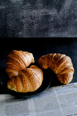 croissants on a dark concrete background. minimalist. free space 