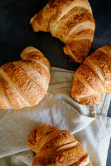 Delicious breakfast with delicious and fresh croissants on a dark concrete background. Top view. 