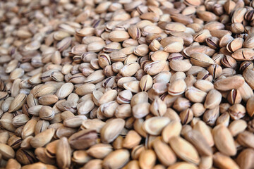 Heap of pistachios in a nutshell selective focus background