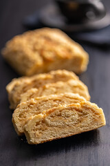 Sweet pie with nut flavor on black table.