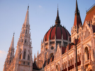 Fototapeta premium Budapest, Hungary - June 26 2022: Parliament building, Országház, parliament of Hungary. The parliament building in Budapest seen from below at sunset. Warm sunset in Budapest over the Danube