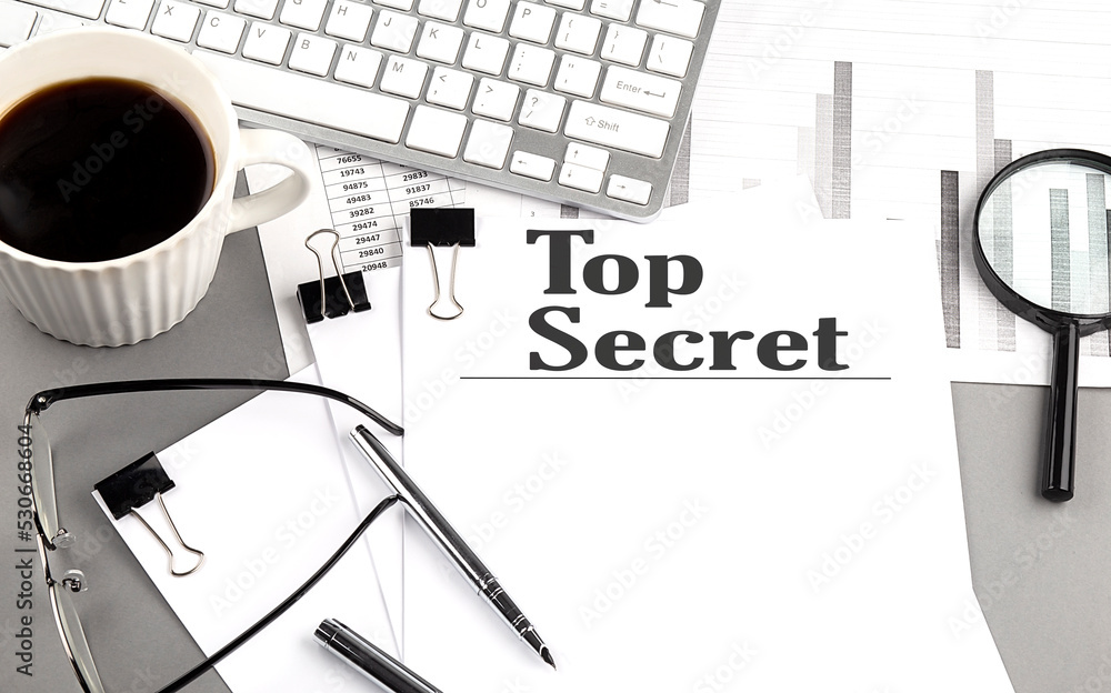 Fototapete top secret text on a paper with magnifier, coffee and keyboard on grey background