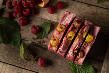 Photo of natural handmade homemade soap on raspberry puree