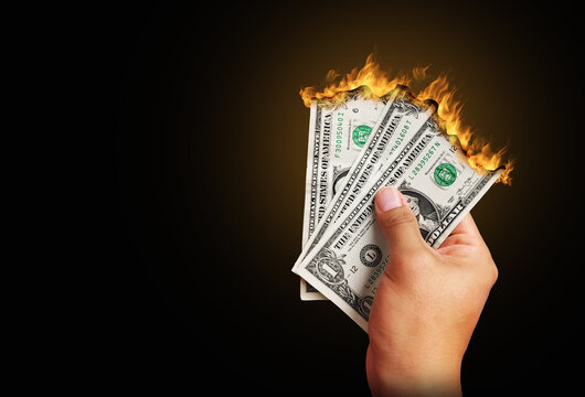 hand holding burning money