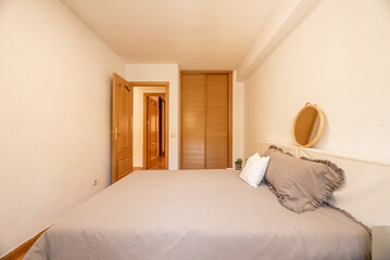 bedroom with a double bed with wooden floors and a wardrobe with Venetian sliding doors