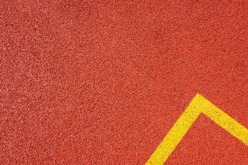 Colorful sports court background. Top view to red field rubber ground with yellow corner lines outdoors