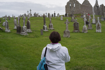 woman observing an old graveyard in ireland