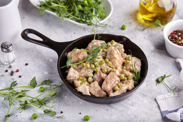 Pork meat stewed with cream sauce onion and green peas.  Delicious homemade dish.