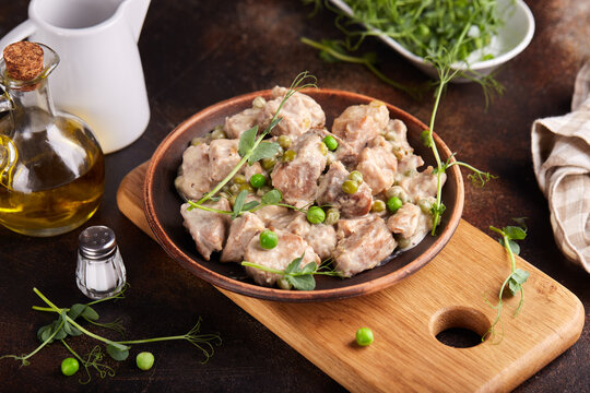 Pork meat stewed with cream sauce onion and green peas.  Delicious homemade dish.