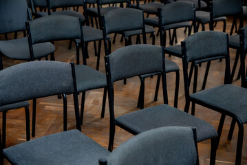 a lot of black chairs for the whole frame, places for spectators
