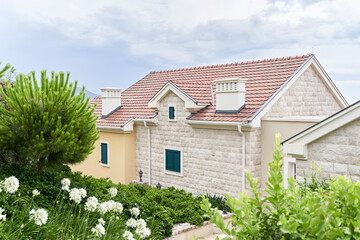 House with modern polymer roofing shingles