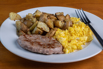 scramble eggs with home  fries and sausage patty
