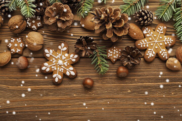 christmas decoration with gingerbread cookies and christmas ornaments on wooden background