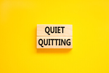 Quiet quitting symbol. Concept words Quiet quitting on wooden blocks. Beautiful yellow table yellow background. Business and quiet quitting concept. Copy space. - obrazy, fototapety, plakaty