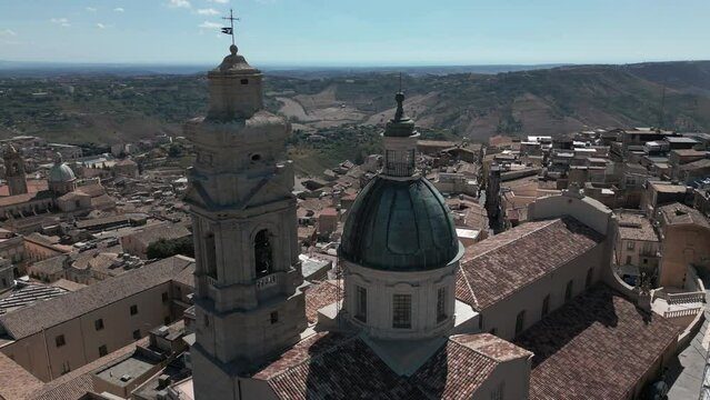 flying clockwise around church at top of hill town of Caltagirone Sicily