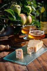 Cheese pairing with drinks,  parmigiano reggiano or parmesan cheese and French apple cider served outdoor