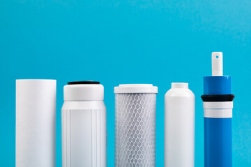filter cartridges for water on a bright blue background.