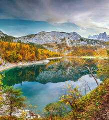 Picturesque Hinterer Gosausee lake, Upper Austria. Autumn Alps mountain lake with reflections. Dachstein summit and glacier in far.