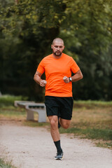 Athletic young man running in nature. Healthy lifestyle