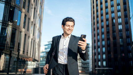 An employee of the company goes to work, holds a phone in his hands.