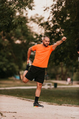 Happy positive sportsman during outdoor workout, man wearing sports outfit warming up muscles,enjoying active lifestyle outside in park