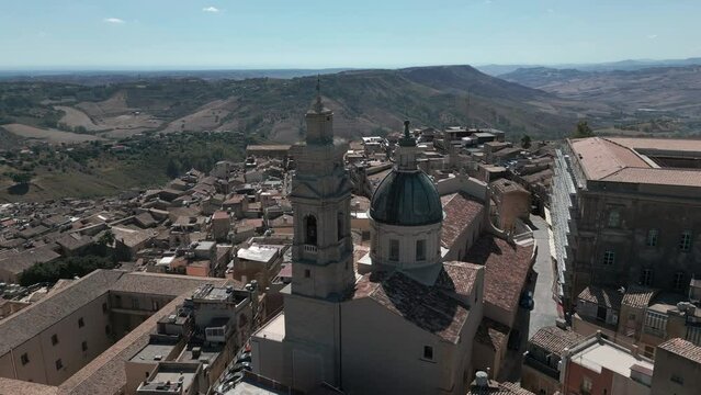 flying over church at top of hill town of Caltagirone Sicily