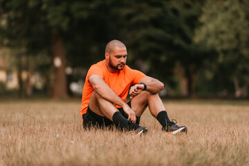 Fototapeta premium Athlete resting after a strenuous morning run