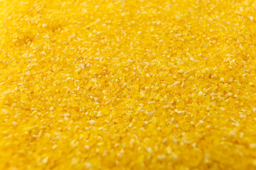 corn grits background. nutrition. food ingredient. shallow depth of field.