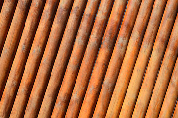 Orange brown wooden wall with cracked paint and cracks, abstract texture background