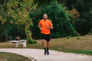 Athletic young man running in nature. Healthy lifestyle