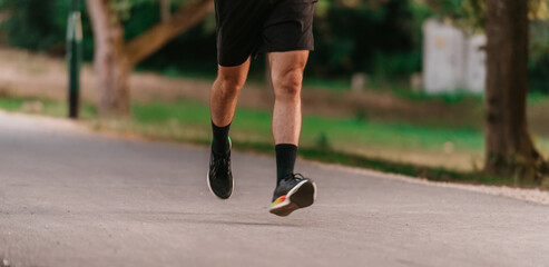 Fototapeta premium Athletic young man running in nature. Healthy lifestyle