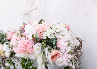 light bouquet of artificial flowers for a holiday, elegant background