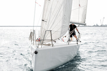 Front close-up view of a sailing yacht during regatta