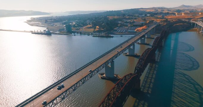 Flying over the bridges leading to Martinez, California, USA. Beautiful American city scenery at sunny daytime. Aerial view.