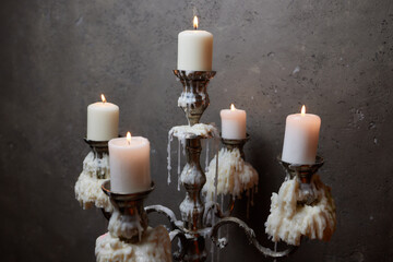 Group of evil candles burning in the darkness and copy space on wooden background. Black magic...