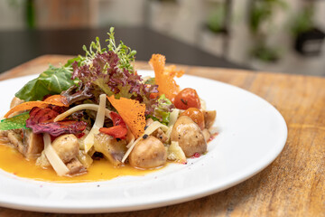 salads on a white plate with a light wood background