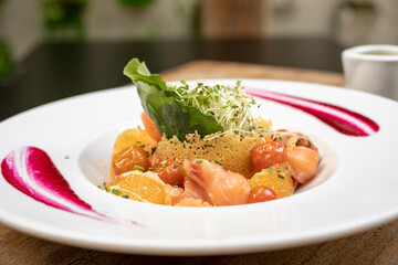 salads on a white plate with a light wood background