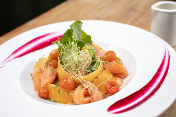 salads on a white plate with a light wood background