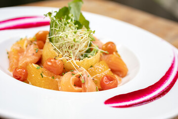salads on a white plate with a light wood background