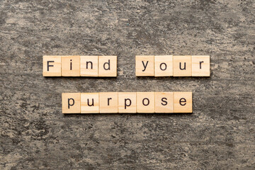 find your purpose word written on wood block. find your purpose text on table, concept
