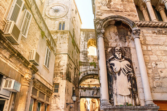 Cityscape - view of the ancient street in the city of Split with the statue of Saint Anthony on the facade of the Ciprianis Palace, the Adriatic coast of Croatia