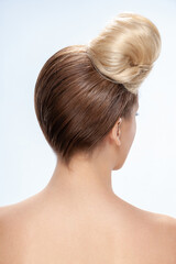 Fototapeta premium Back view of young woman. Portrait of a naked young white woman. Dark hair. Stylish hairstyle. Light background