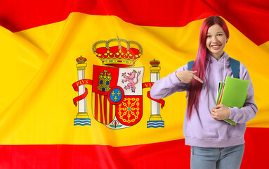 Young female student against flag of Spain. Concept of studying Spanish