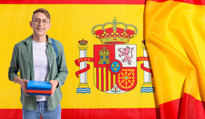 Student with books against flag of Spain. Concept of studying Spanish