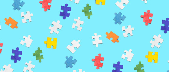 Fototapeta na wymiar Many pieces of jigsaw puzzle on blue background. Pattern for design