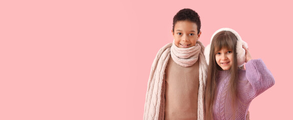 Cute little children in winter sweaters on pink background with space for text