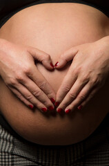 Mother embracing her baby bump