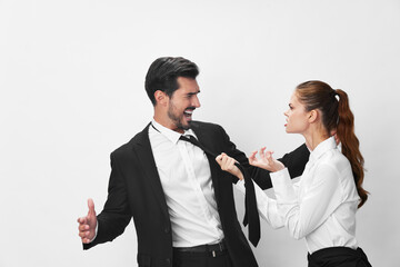 Man and woman anger business hitting on each other screaming with their hands up in the air on a white isolated background. The concept of business in a couple harassment startup copy space
